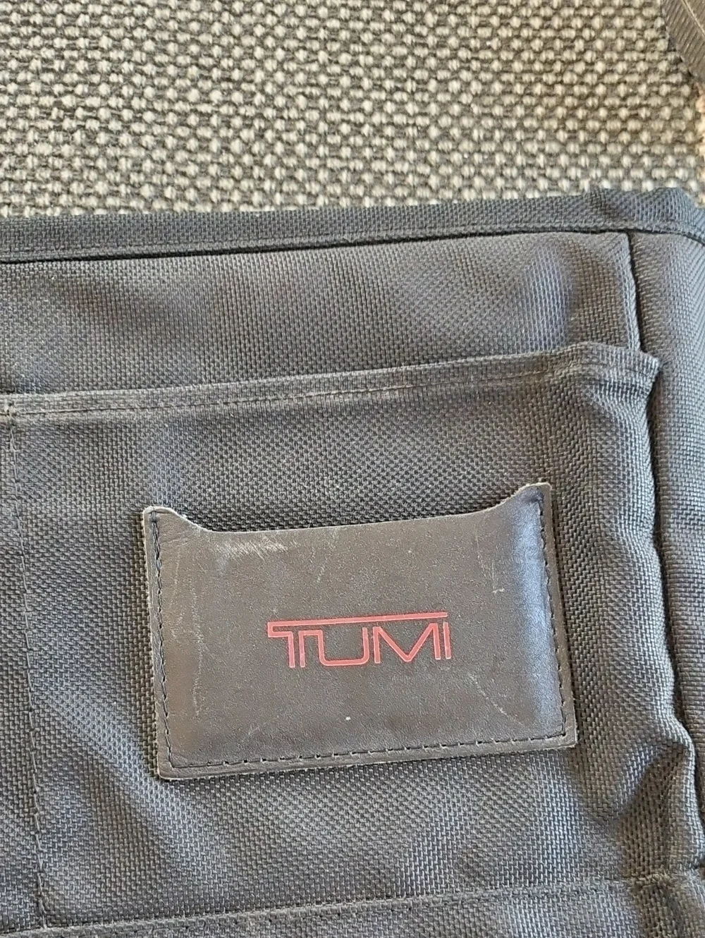 Tumi Black Laptop Sleeve with Red Logo Accent